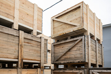 A stack of huge wooden crates in a storage area. Big boxes of goods in an open-air warehouse...