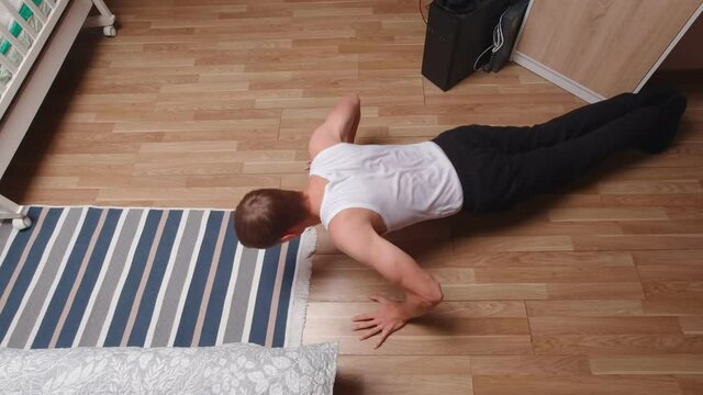 Man pushing up top view white undershirt home interior