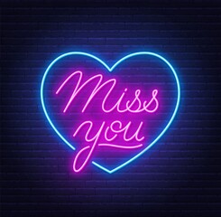 Miss You neon quote on brick wall background. © TanyaFox