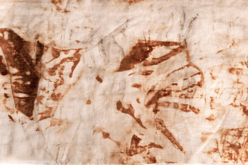 The texture of an old linen cloth, covered with dirt and rust. Background grange. The rusty fabric is streaked.