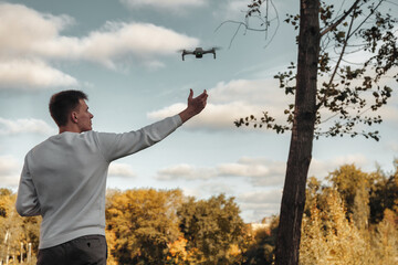 Drone quadrocopter taking off from man hands outdoors