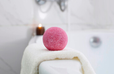 Close-up of a pink ball. bath bomb scented candle in the bathroom. The concept of therapy....