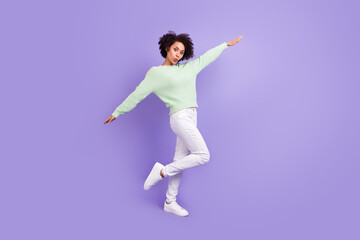 Fototapeta na wymiar Full length photo of young dark skin positive woman hands plane wings fly isolated on purple color background