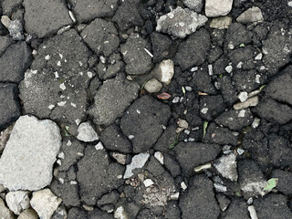 Broken asphalt texture close up