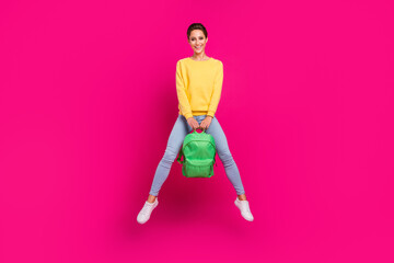 Fototapeta na wymiar Full length body size view of attractive cheerful girl jumping holding school bag isolated over bright pink color background