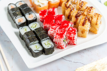 sushi rolls on a white plate on a white background