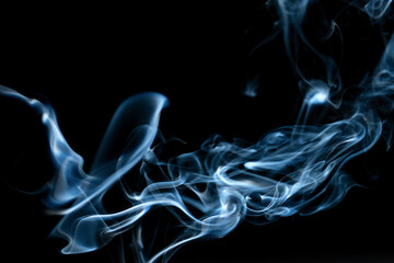 Obraz premium Abstract colored smoke moves on dark background. Wallpaper. Personal vaporizers fragrant steam. Concept of alternative non-nicotine smoking. E-cigarette. Texture. Design elements.