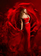 Sexy Model in Red Dress dancing over Fantasy Rose Background. Beauty Woman Art Portrait. Luxury...