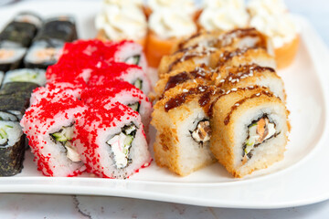 sushi rolls on a white plate on a white background