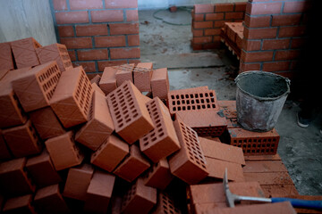 pallets and packages of freshly produced red bricks in a construction warehouse on the street. Concept of repair and building materials