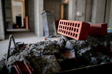 pallets and packages of freshly produced red bricks in a construction warehouse on the street. Concept of repair and building materials