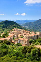 The village of Sainte-Lucie-de-Tallano in the south of corsica island, France. The village lies in the middle of orchards, olive trees an vineyards. - obrazy, fototapety, plakaty
