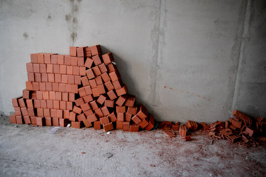 pallets and packages of freshly produced red bricks in a construction warehouse on the street. Concept of repair and building materials