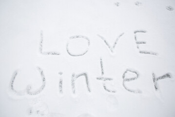snow with the inscription love winter. Christmas Eve walks, fun, winter holidays