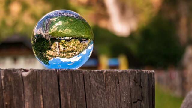 Crystal ball alpine landscape shot at the famous Fallbach waterfall, the highest waterfall in Kaernten, Maltatal, Austria