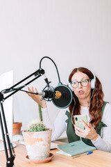 blogger discussing in podcast wearing headphones, on-air production internet broadcast