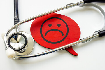 Bad or negative patient experience. Stethoscope and unhappy face.