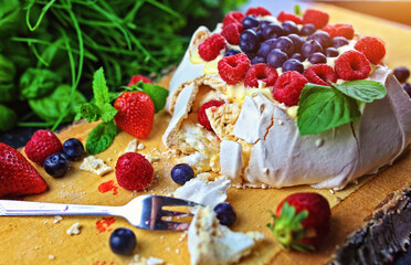 Delicious pavlova meringue with raspberries, strawberries and blueberries