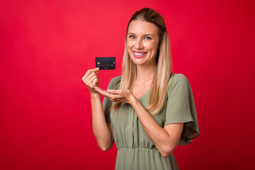 Photo of mature blond lady indicate card wear khaki dress isolated on red color background