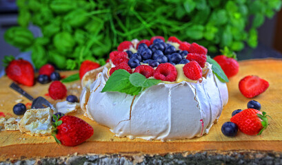 Delicious pavlova meringue with raspberries, strawberries and blueberries