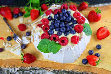 Delicious pavlova meringue with raspberries, strawberries and blueberries