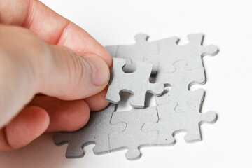 Person adding last piece of jigsaw puzzle