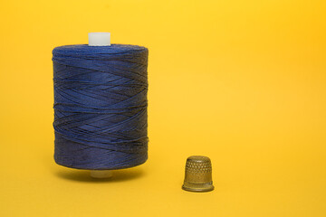 Spool of thread and thimble