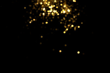 Golden blurred bokeh lights on black background. Glitter sparkle stars for celebrate. Overlay for your design