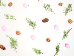 Christmas pattern. New Year decorations on blue background. Thuja, cones and сhristmas decorations. Flat lay, top view.