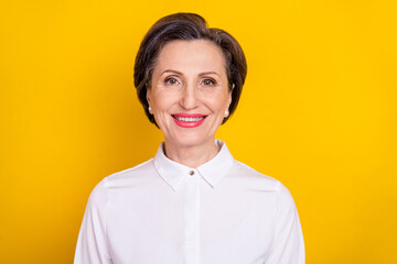 Photo of adorable shiny mature lady wear white clothes smiling isolated yellow color background