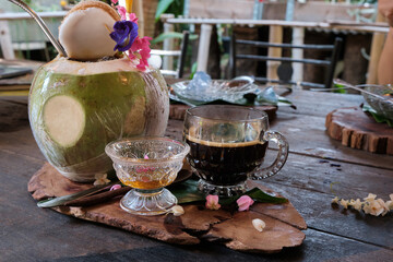 Indulge in organic black coffee served with honey, coconut on a relaxing day in the comfort of a home garden cafe. 
