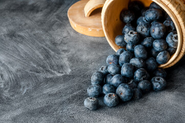Blueberries close up macro on a black slate background.