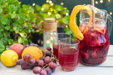 Refreshing sangria of wine and fruits with defocused bokeh background