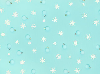 Fototapeta na wymiar Christmas pattern. New Year decorations on blue background. Snowflakes, сhristmas decorations. Flat lay, top view.