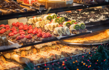 Desserts with cake fruits, mousse, biscuits. Fruit and berry biscuits dessert tray assorted. Beautiful delicious tarts, bright, colorful pastry cakes sweets with fresh raspberries. French bakery.