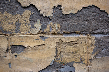 Ancient wall with peeling plaster. Old concrete wall, panoramic textured background