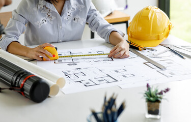 Architect design engineer working drawing sketch plans blueprints and making architectural...