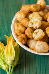 Zucchini Flower Donuts. A typical delicacy of Neapolitan cuisine are fried meatballs with zucchini flowers inside, a great way to cook zucchini flowers.