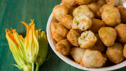 Zucchini Flower Donuts. A typical delicacy of Neapolitan cuisine are fried meatballs with zucchini flowers inside, a great way to cook zucchini flowers.