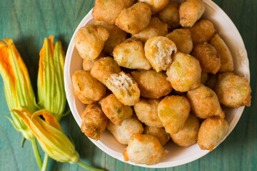 Zucchini Flower Donuts. A typical delicacy of Neapolitan cuisine are fried meatballs with zucchini flowers inside, a great way to cook zucchini flowers.