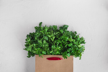 Full bag with fresh parsley on white background