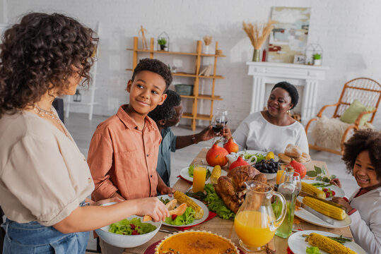 African American Family Celebrating Thanksgiving With Tasty Food At Home