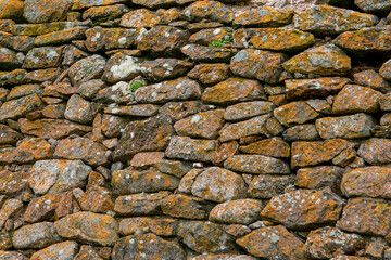 A wall of rough mountain stones. Background of mountain stones