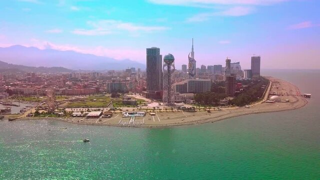Aerial photography of the beautiful Batumi, made with the help of a drone in sunny summer weather. Batumi, Adjara. A park in the center of the city with a Ferris wheel and an alphabet tower.