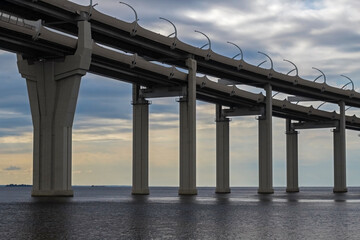 Automobile bridge over the Gulf of Finland. A bridge on high supports on background sky. Concept - road architecture. Expressways on bridges. Highway.