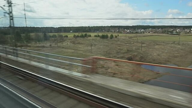 View of outside landscape, shot from running Super fast bullet train from Moscow to St. Petersburg.