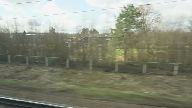 View of outside landscape, shot from running Super fast bullet train from Moscow to St. Petersburg.