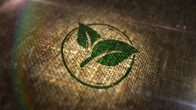 Green leaf eco friendly symbol sign stamp on natural linen sack. Co2 neutral, ecology, environment and climate, organic coffee or cocoa production 3D design abstract concept. Looped and seamless.