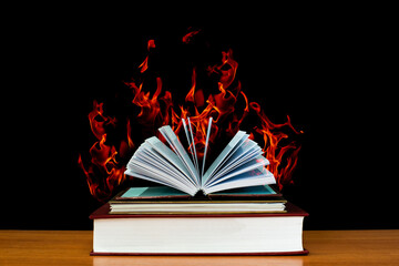 The book was opened with a burning flame. book fire