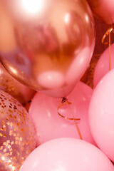 Balloons of pink and gold color close-up.